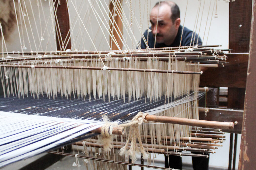 home weaver at multi peddle loom